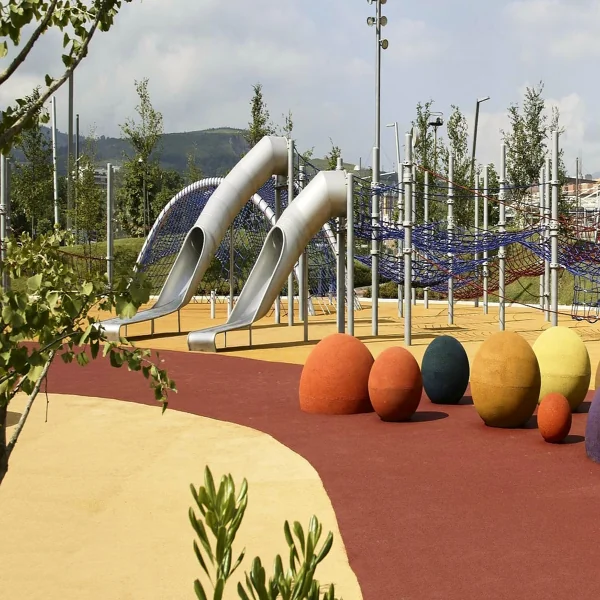 ground with slides, colorful egg-shaped climbing structures.