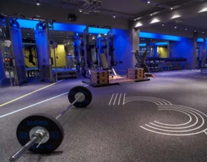 A dark gym with speckled rubber flooring