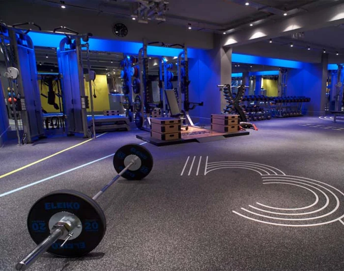 A dark gym with speckled rubber flooring