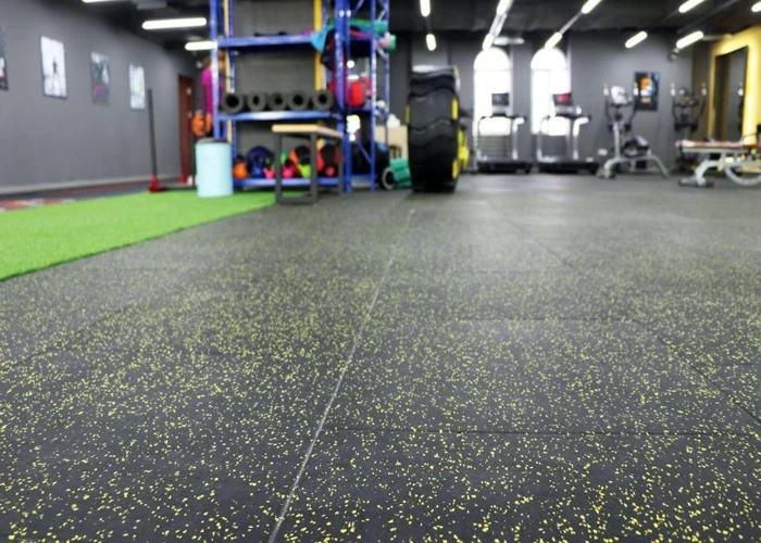 Black rubber flooring with yellow speckles in gym
