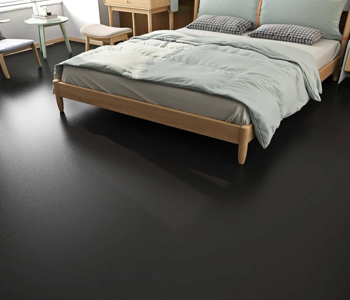 Dark solid rubber flooring in a bedroom