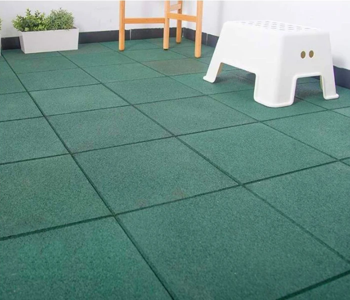 Green square interlocking rubber floor tiles indoors