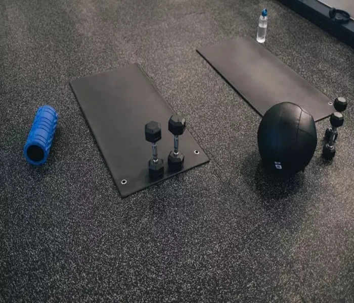 Weights on speckled rubber gym floor tiles (1)