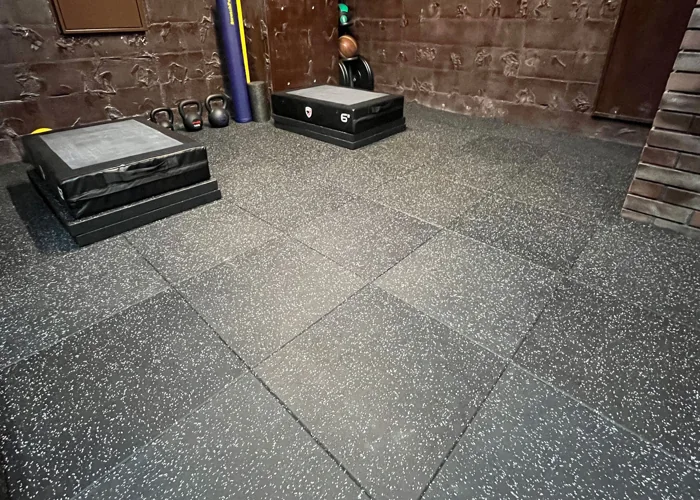 gym floor with speckled black rubber interlocking tiles