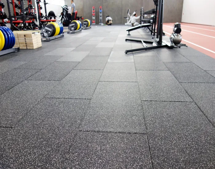gym with black and gray rubber floor tiles.