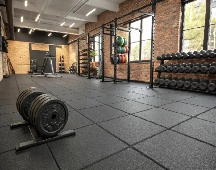 gym with tiled black rubber flooring.