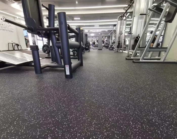 large gym with speckled rubber floor tiles