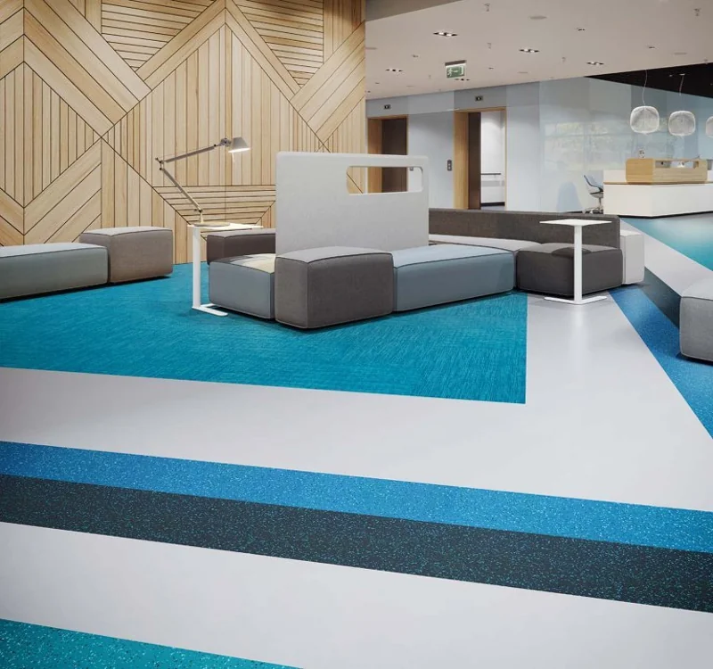 Color-blocked rubber and carpet flooring in modern lobby