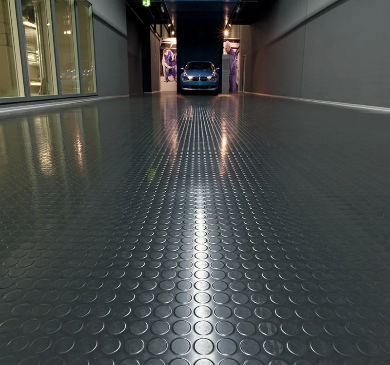 Dark grey studded rubber sheet flooring in hallway