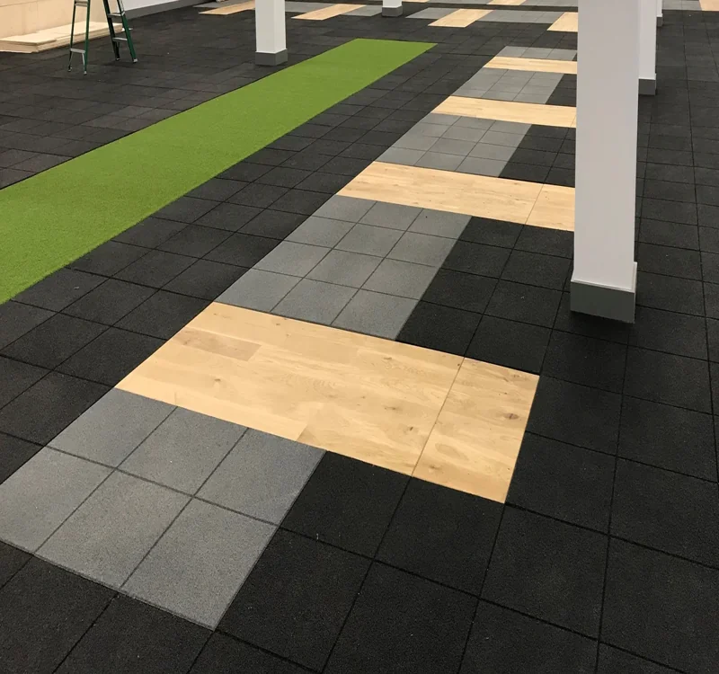 Interlocking black rubber gym flooring with accents